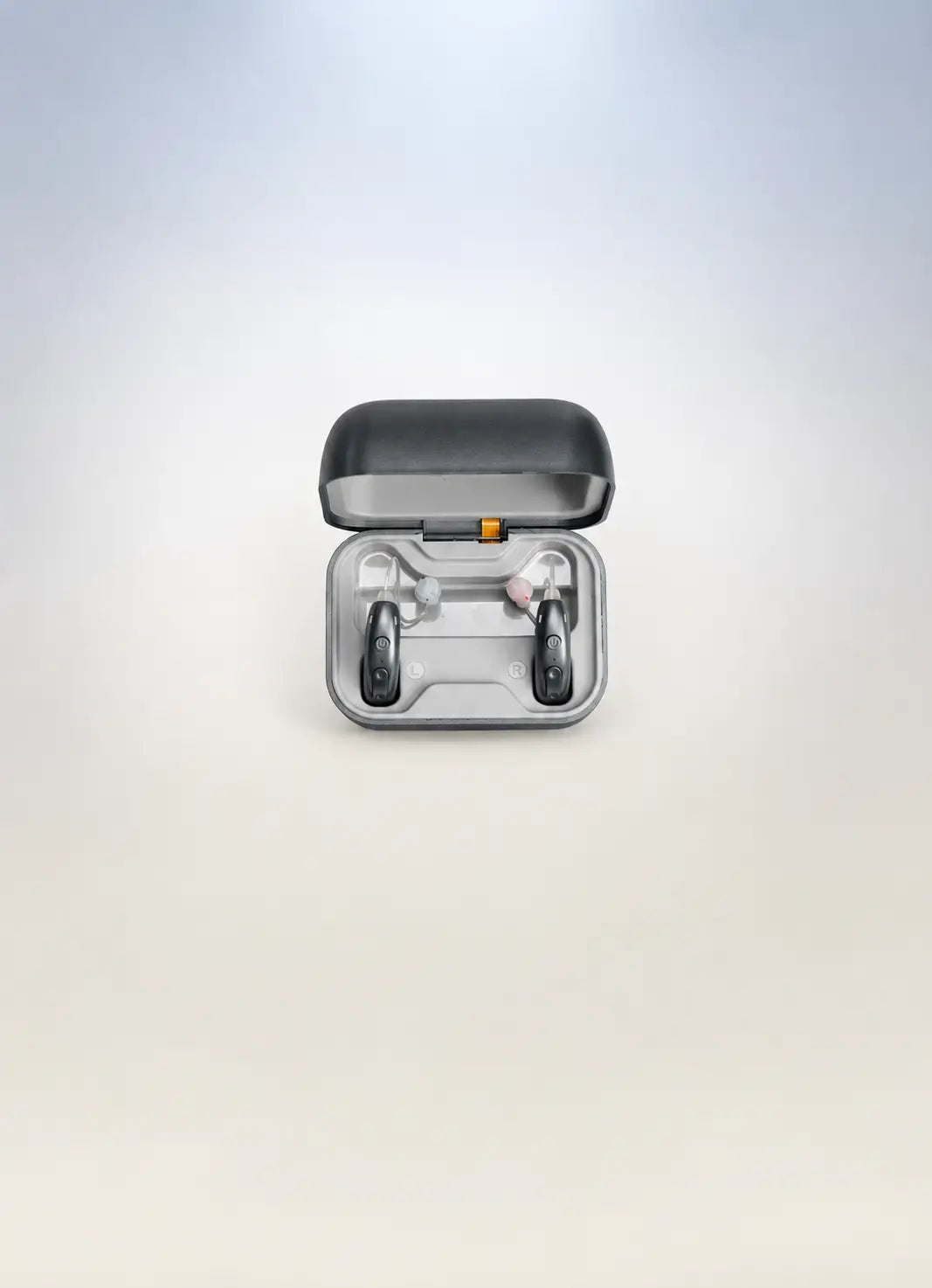 Front view of open charging case showing a pair of grey AuyeeSnc OmniTouch hearing aids