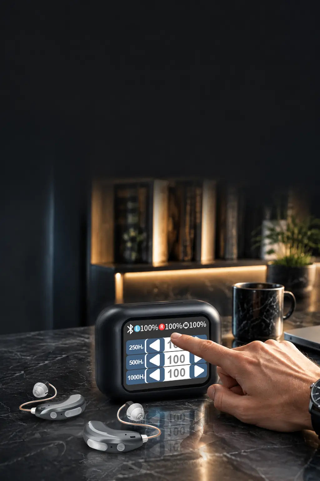 Close-up of a hand entering frequency tuning values directly on the AuyeeSnc OmniTouch touchscreen case next to RIC hearing aids.